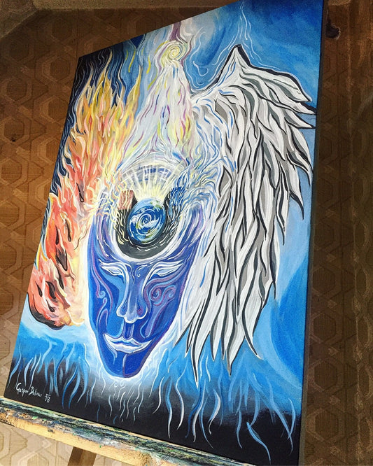 The painting Law of Attraction shows a blue head with an angel wing on the right and a burning wing on the left, highlighting the mind’s power to attract energy.